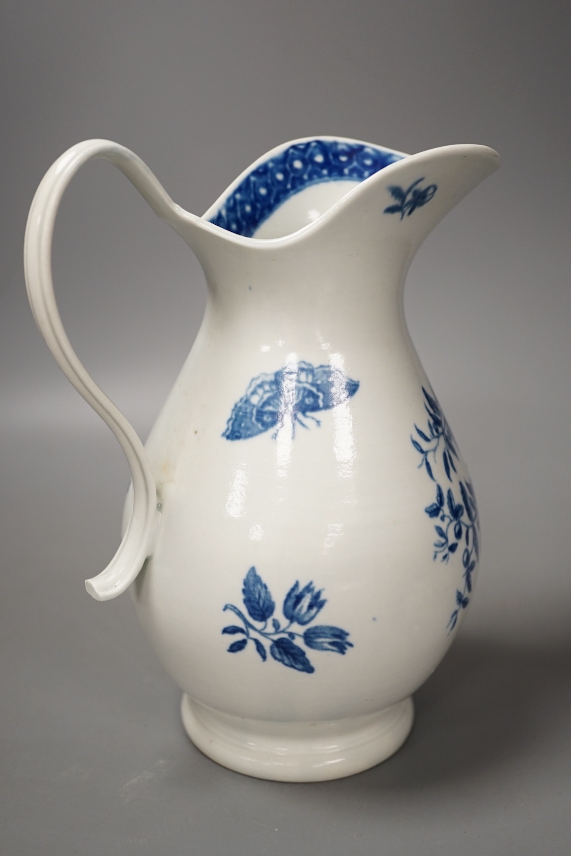 A Worcester French style water ewer decorated in under-glaze blue with fir cones and rose hips c. 1775, 21cm